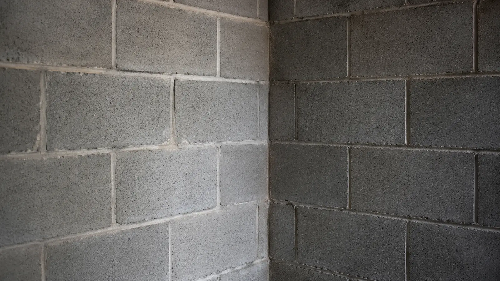 The inside corner of a clean concrete block basement wall.